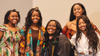 smiling women surrounding graduate